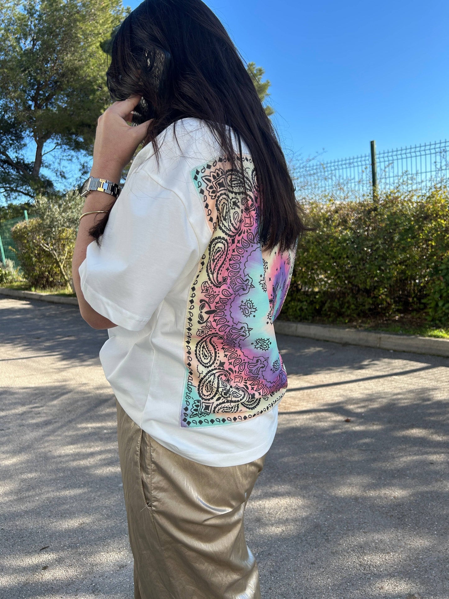T-shirt ample femme Adoré, blanc avec un motif bandana coloré au dos. Idéal pour un style tendance et décontracté en 2025.